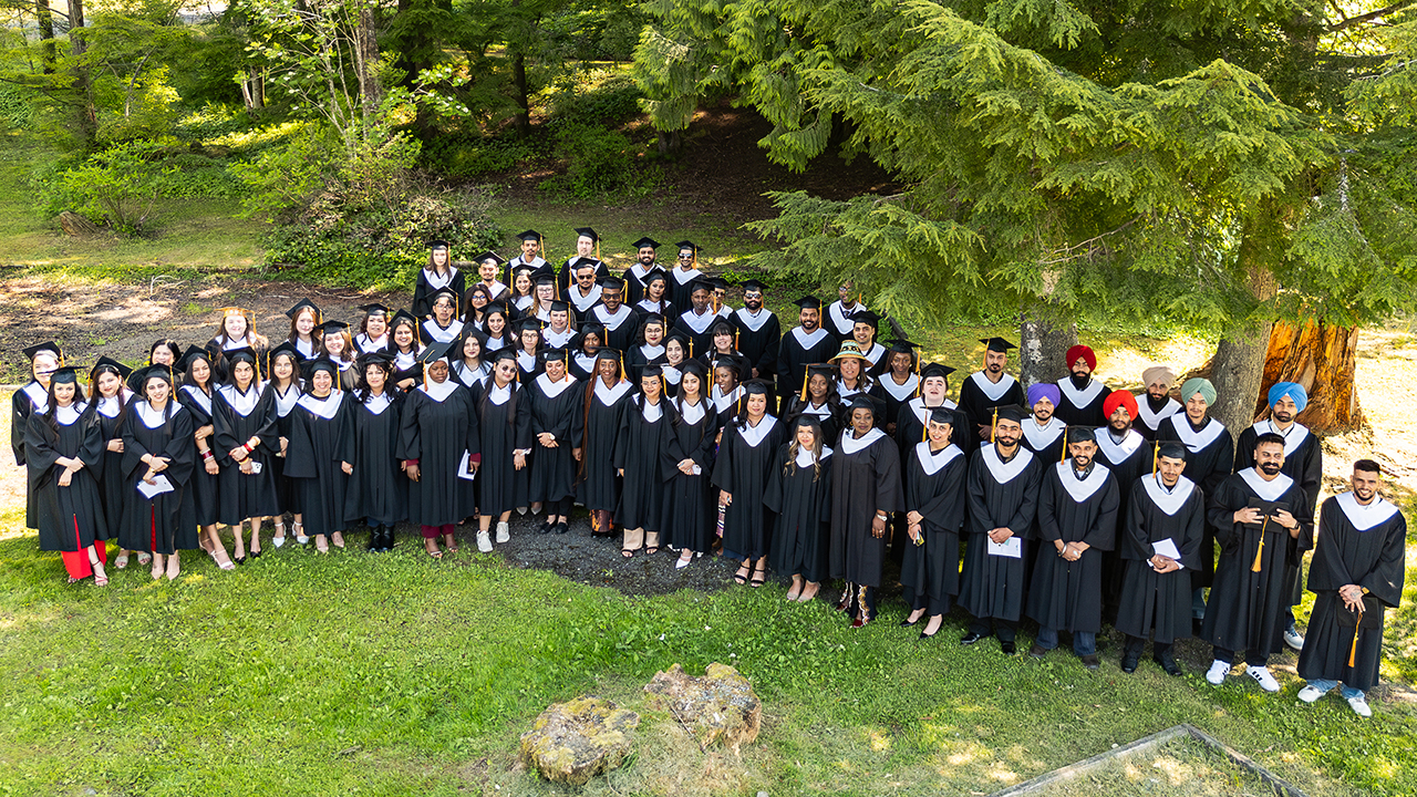 The CMTN Prince Rupert Class of 2026 poses on a lawn under cedar trees.